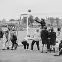 Local schoolboys watch the West German team training at Ashbourne during the 1966 World Cup in July 1966.