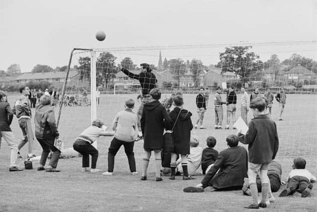 Local schoolboys watch the West German team training at Ashbourne during the 1966 World Cup in July 1966.