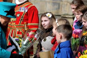The Queen collects flowers from children outside Sheffield Cathedral for Maundy Thursday during a 2015 visit. Picture: Andrew Roe