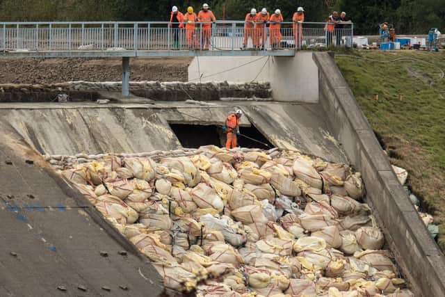 Engineers and members of the emergency services assess the damaged spillway of the Toddbrook Reservoir dam on August 5, 2019.   (Photo - OLI SCARFF/AFP/Getty Images)