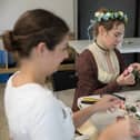 Regency ladies creating new headdresses preparing for the Regency ball.