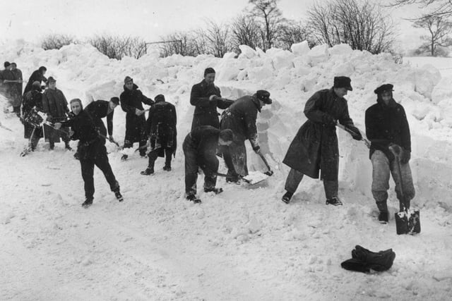 German prisoners of war clearing snow from the Whaley Bridge to Buxton road near Chapel-en-le-Frith aftrer Britain's worst blizzards for 50 years on 6th February 1947.
