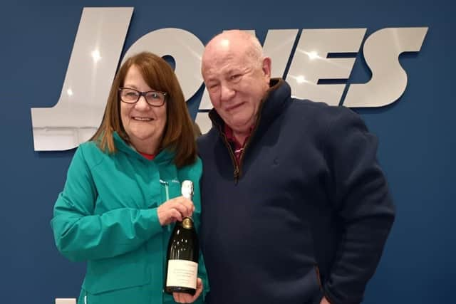 Judith and Steve with their personalised bottle of champagne, that they were gifted