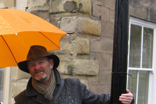 Keith Savage under an umbrella