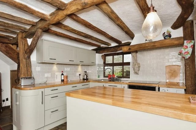 An oak door to the front opens into the L shaped dining kitchen.