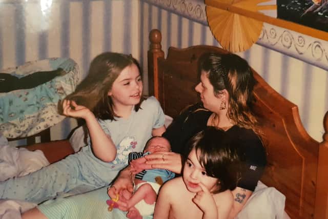 Tracey with Katie aged 8, left, with newborn Cole and two-year-old Chloe.