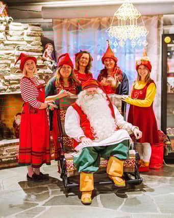 Santa Claus and his helpers ready to receive letters from around the world