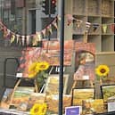 colourful paintings by Hazel Money in the window of Headmasters, on Union Road.