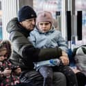 A Ukrainian refugee hugs his grandchild at a Ukrainian refugee centre during the early days of the conflict. (Photo by Hristo Rusev/Getty Images)