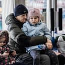 A Ukrainian refugee hugs his grandchild at a Ukrainian refugee centre during the early days of the conflict. (Photo by Hristo Rusev/Getty Images)