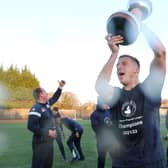 Josh Granite lifts the trophy as champions Buxton can finally celebrate.