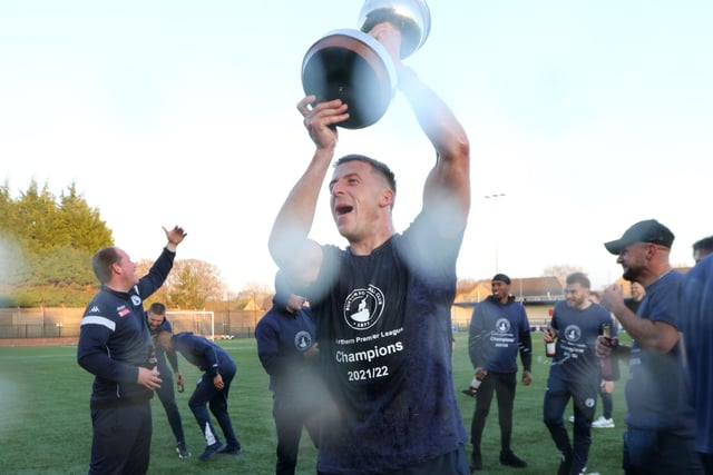 Josh Granite lifts the trophy as champions Buxton can finally celebrate.