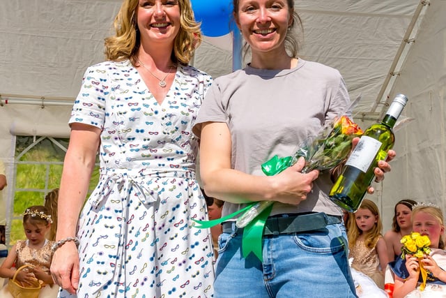 Smiles in the sunshine as flowers and wine were handed over. Picture Anthony McKeown