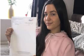 Amy Lee, proudly displaying her grade four GCSE maths result, achieved with help from tutors at Buxton & Leek College.