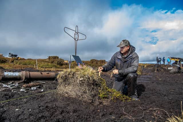 Tim Fletcher from Geoscope Services pays his respects during the search for lost WWII American airman Corporal Clarence Watson at Twizle Head Moss Crash Site on Holme Moss near Holmfirth. On 9 October 2026 it was 82 years to the date a B-24H Liberator aircraft 'Sack Time' crashed on a hillside during a training flight in poor visibility, killing all but one of the people onboard.  Picture by Tony Johnson.