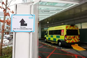 A sign directs patients towards an NHS 111 Coronavirus (COVID-19) Pod, where people who believe they may be suffering from the virus can attend and speak to doctors(Photo by ISABEL INFANTES/AFP via Getty Images)