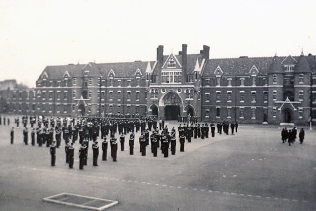This is a view of Divisions on Victoria Barracks parade ground in 1954. This vista is from the Duchess of Kent Barracks and we see sailors and wrens standing to attention.