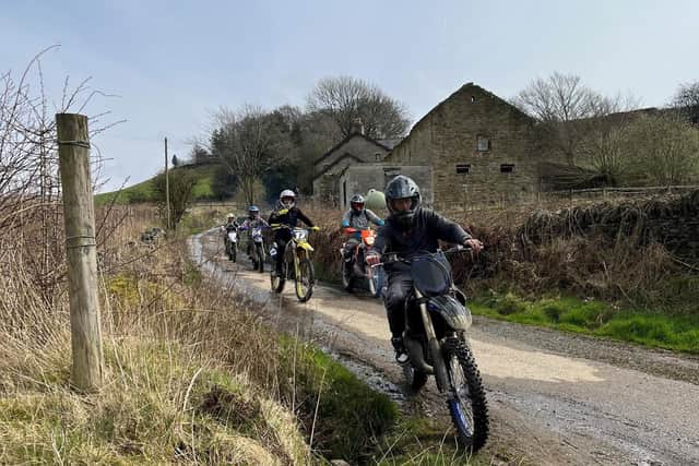 A woman was videoing a group of off-road bikers on a lane in Rowarth just after 2 pm on Sunday, April 9, when one of the group attempted to grab her mobile phone before punching her.