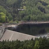 A Lancaster bomber flies over Ladybower reservoir to mark the 70th anniversary of the World War II Dambusters mission on May 16, 2013. (Photo by Christopher Furlong/Getty Images)