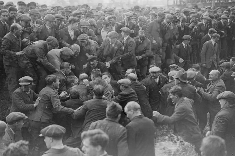 A game of Shrovetide football, ' kicked - off ' by the Prince of Wales in Ashbourne, is getting rather rough, in February 1928.