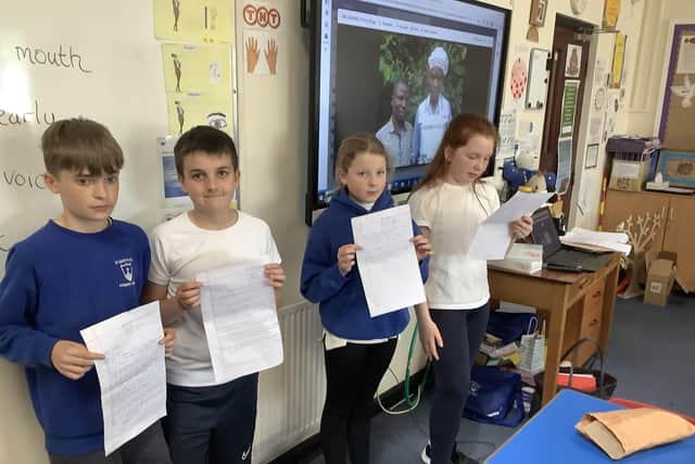 Year 5 and 6 pupils holding some of the letters written by pupils in their sister school Busyangwa in Uganda. Pic submitted