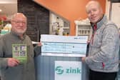 Author Julian Cohen donates £1,500 from the sale of his new book, which looks at the history of four shops in the town, to Buxton charity Zink. Photo submitted