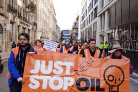 Paul Barnes, pictured right of the protester in the blue mask, demonstrating with Just Stop Oil on May 10.