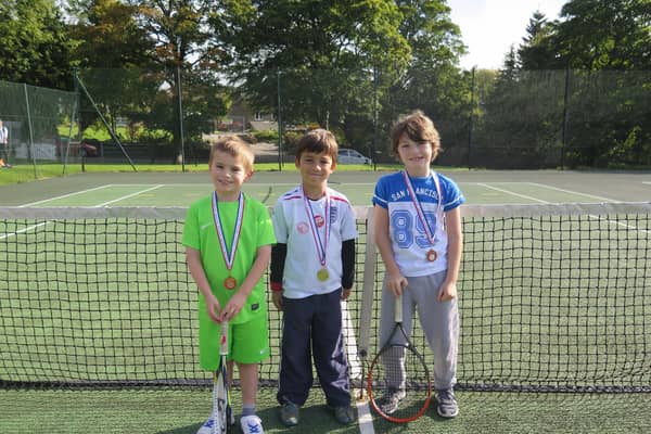 Three youngsters get ready to play at Buxton Tennis Club.