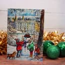 The card depicts children making a snowman in front of Chatsworth House.