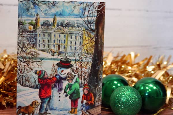 The card depicts children making a snowman in front of Chatsworth House.