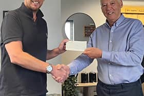 Andy Cunningham, right, is presented with his winnings by Rob Turner