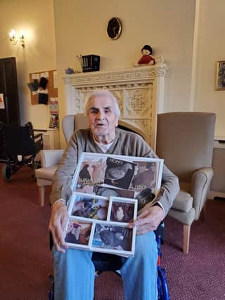 The 87-year-old with photographs of his pigeons.