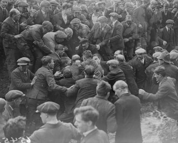 A game of Shrovetide football, ' kicked - off ' by the Prince of Wales in Ashbourne, is getting rather rough, in February 1928.