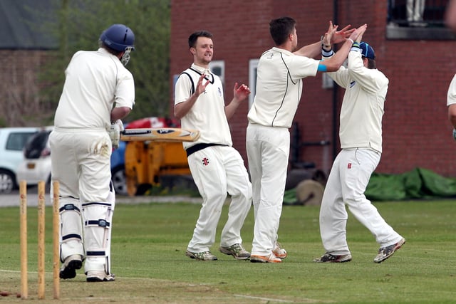 Hadfield's Rick Trunter celebrates taking a wicket against New Mills.