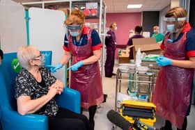 A nurse prepares to administer the Pfizer-BioNTech COVID-19 vaccine to patient Trixie Walker  (Photo by Andy Stenning / POOL / AFP) (Photo by ANDY STENNING/POOL/AFP via Getty Images)