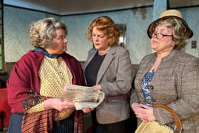 Bunny (Helen Bates), Letty (Charlie Weatherly), and Miss Marple (Sheila Rowley) examine the murder announcement