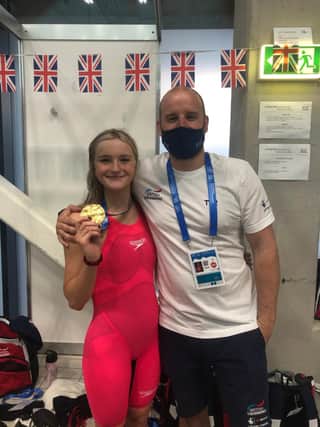 Abbie Wood shows off her second gold medal alongside coach Dave Hemmings in Budapest. She has two more individual events later this week. (Photo courtesy of Dave Hemmings)