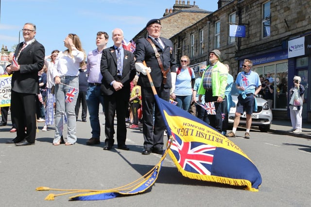 During the Whaley Bridge Platinum Jubilee Parade, the Royal British Legion standard is lowered for the singing of the national anthem