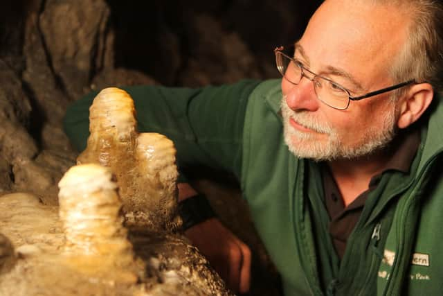 Pooles Cavern manager Alan Walker with some of the stalagmites that have been growing undisturbed during lockdown