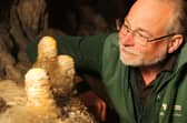 Pooles Cavern manager Alan Walker with some of the stalagmites that have been growing undisturbed during lockdown