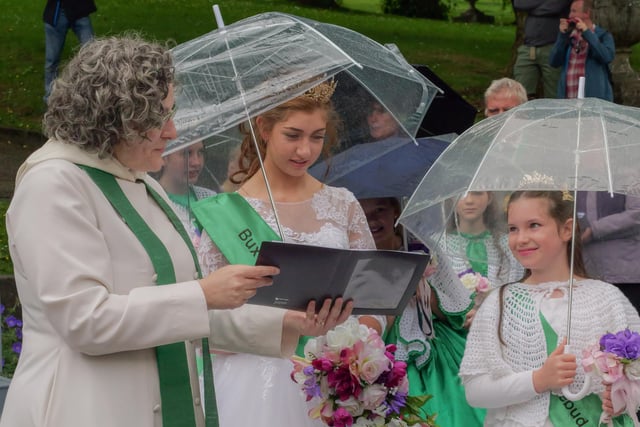 Rev Liz England and Carnival Queen share a hymn book in the rain. Picture Roger Beverley