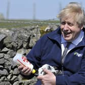 Prime Minister Boris Johnson feeds a lamb during a visit to the Moor Farm in Stoney Middleton as part of the election campaign