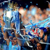 Sergio Aguero holds the Premier League trophy aloft after his injury-time heroics in 2012.