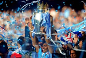 Sergio Aguero holds the Premier League trophy aloft after his injury-time heroics in 2012.