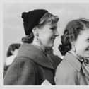 Johnny Ray fans from Derbyshire are pictured waiting patiently at the London Airport. Johnny Ray, the famous American crooner, arrived at the airport and the teenage fan club presidents were there to meet him and returned to the Dorchester Hotel with him for a lemonade. The two lucky girls - Jill James (18) and Philippa Henderson (15) are seen wearing Johnny Ray picture earings.