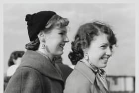 Johnny Ray fans from Derbyshire are pictured waiting patiently at the London Airport. Johnny Ray, the famous American crooner, arrived at the airport and the teenage fan club presidents were there to meet him and returned to the Dorchester Hotel with him for a lemonade. The two lucky girls - Jill James (18) and Philippa Henderson (15) are seen wearing Johnny Ray picture earings.