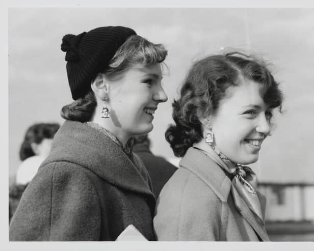 Johnny Ray fans from Derbyshire are pictured waiting patiently at the London Airport. Johnny Ray, the famous American crooner, arrived at the airport and the teenage fan club presidents were there to meet him and returned to the Dorchester Hotel with him for a lemonade. The two lucky girls - Jill James (18) and Philippa Henderson (15) are seen wearing Johnny Ray picture earings.