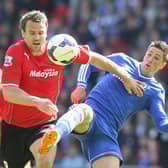 Ben Turner challenges Chelsea's Fernando Torres whilst playing in the Premier League for Cardiff in 2014.