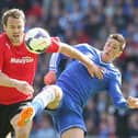 Ben Turner challenges Chelsea's Fernando Torres whilst playing in the Premier League for Cardiff in 2014.