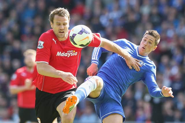 Ben Turner challenges Chelsea's Fernando Torres whilst playing in the Premier League for Cardiff in 2014.